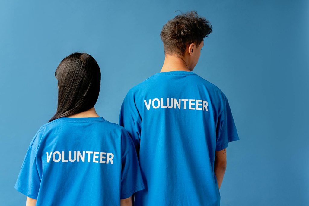 man and woman wearing blue shirts with printed text